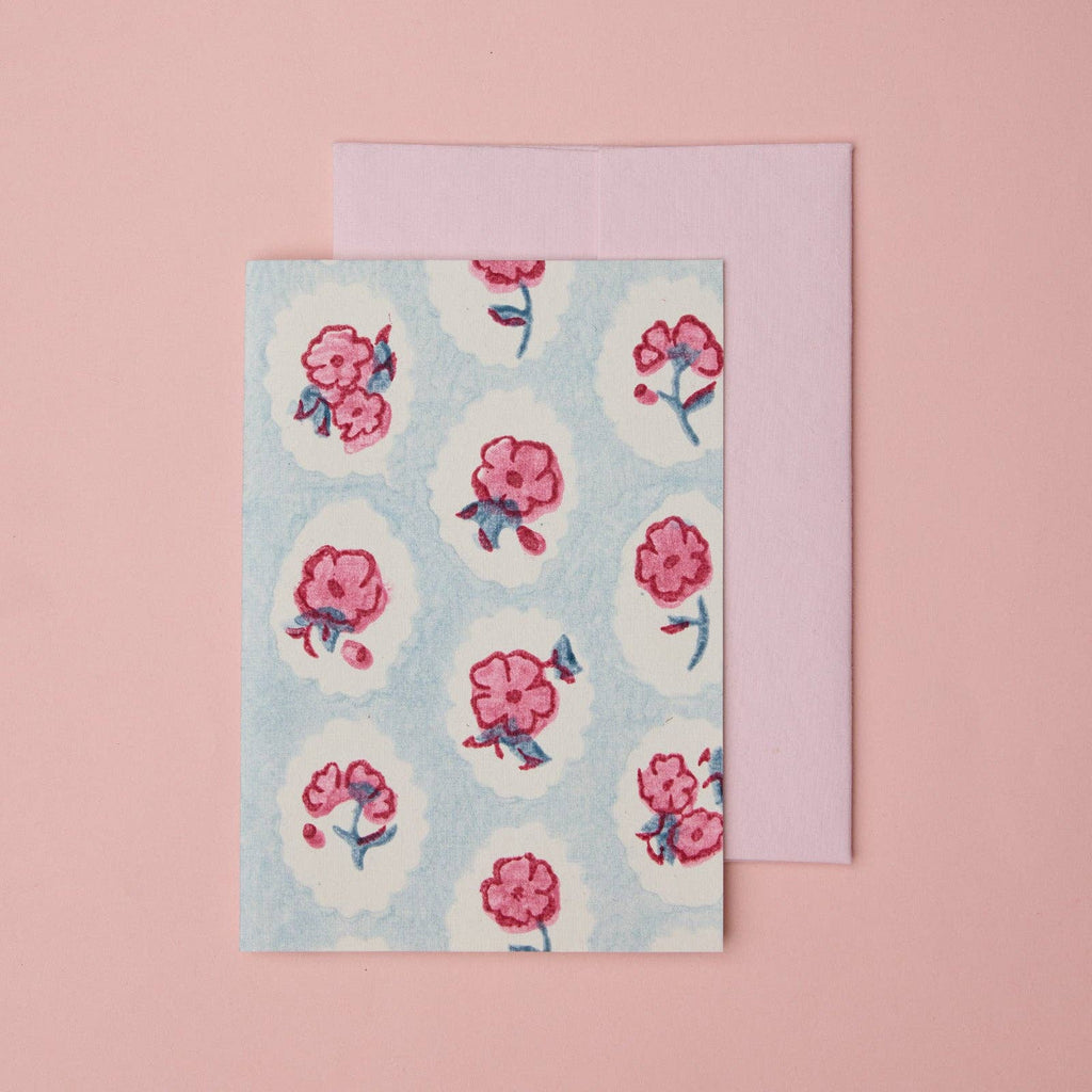 Carte fleurie – Fleurs roses sur fond bleu